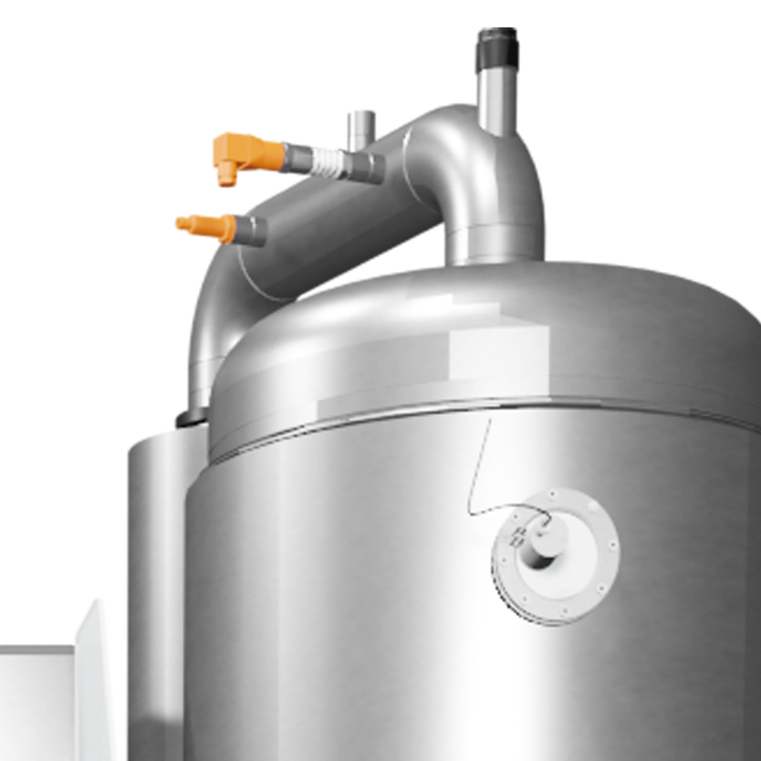 Close-up view of a metallic industrial machine component with pipes and fittings.