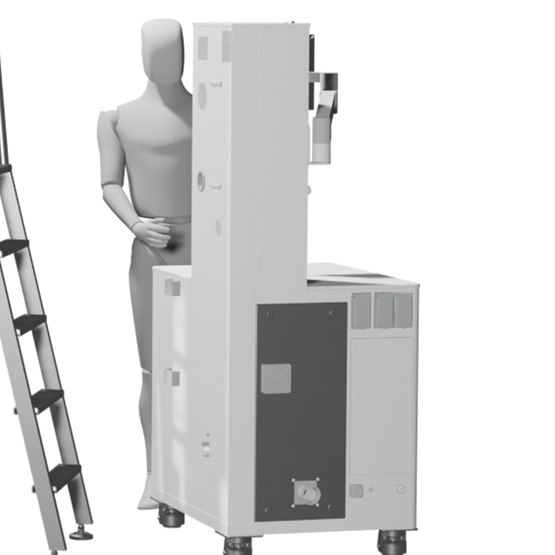 Spray congealing industrial equipment shown with a human figure for scale, illustrating the machinery size used in pharmaceutical processing.
